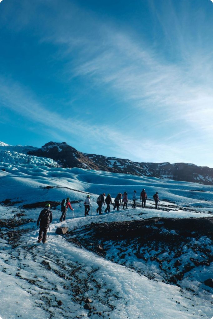 A group walking up a snowy slope of Vatnajökull.